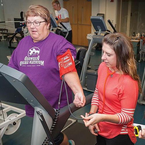 Exercise Science Student working with a patient on the treadmill
