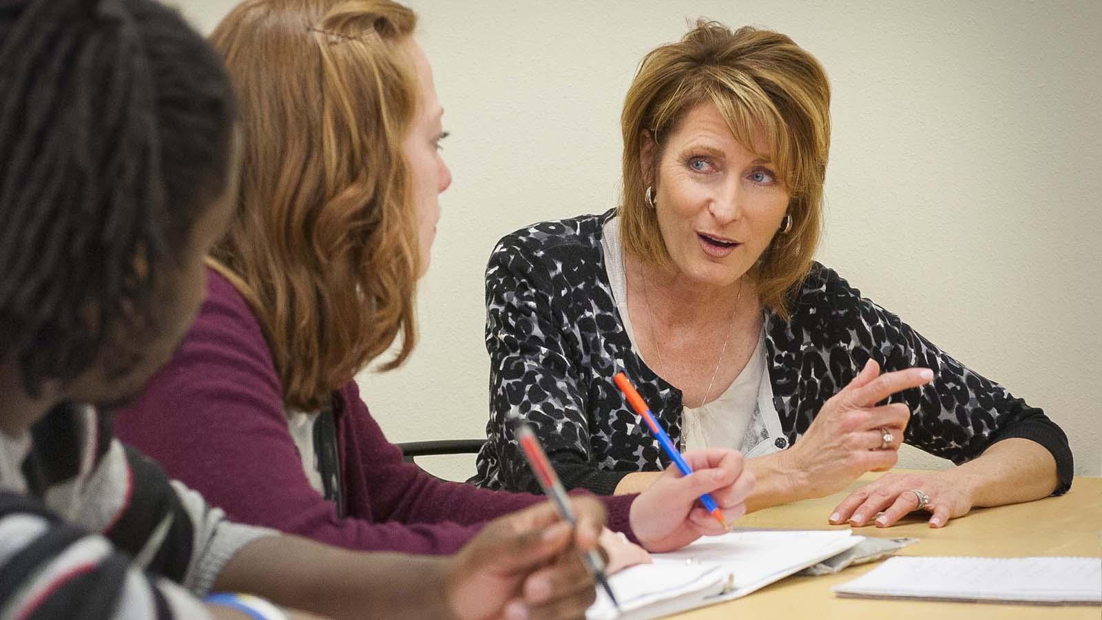 Professor Brenda Tufte engaged with students